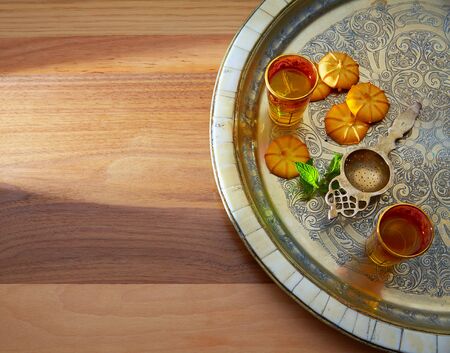 green tea with mint Moroccan style on silver tray and biscuitsの写真素材