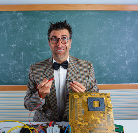 Nerd electronics technician retro teacher silly expression working in pcbの写真素材