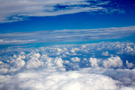 Aerial view of clouds and blue sky while flying on aircraft