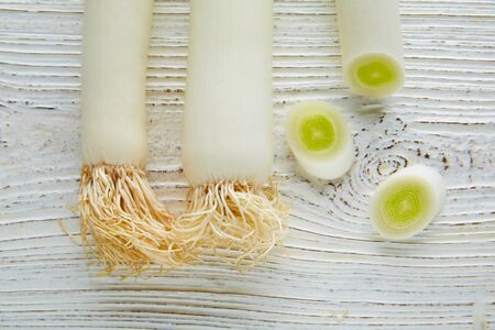 Leeks vegetable raw food with cutted texture in a white wood board table