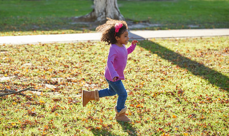 kid girl toddler playing running in park outdoor latin ethnicityの写真素材