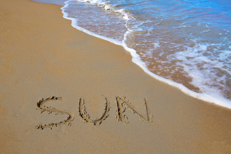 Sun spell written work in sand of a beach in vacationの写真素材