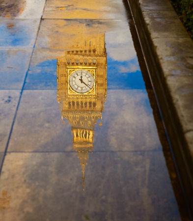 Big Ben Clock Tower puddle water reflection in London Englandの写真素材
