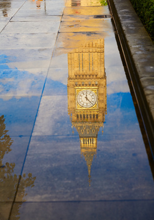 Big Ben Clock Tower puddle water reflection in London Englandの写真素材