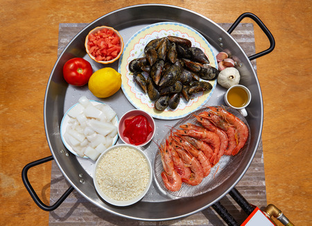 Seafood paella ingredients from Spain cuttlefish rice tomato shrimps