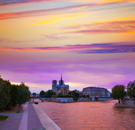 Notre Dame cathedral in Paris sunset from Seine river in Franceの写真素材