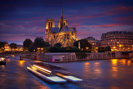 Notre Dame cathedral in Paris sunset from Seine river in Franceの写真素材
