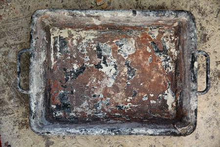 Mason bucket rectangular on debris background in house improvement