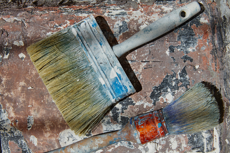 Paint brushes used on grunge bucket in improvement backgroundの写真素材