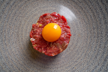 Steak Tartare raw meat recipe with egg yolk modern cuisineの写真素材