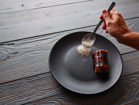 Grilled smoked eel with green apple and citrus chef hand preparingの写真素材