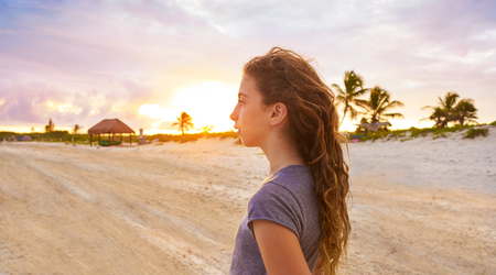 Girl at sunset caribbean beach in Mexico Riviera Maya