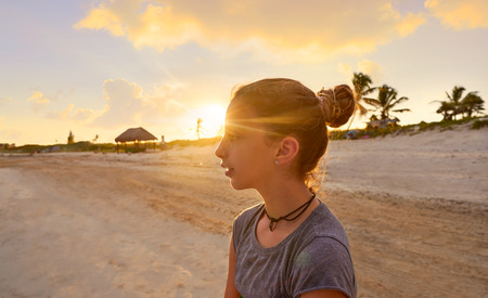 Girl at sunset caribbean beach in Mexico Riviera Maya