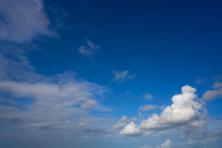 Blue summer sky white cumulus clouds backgroundの写真素材