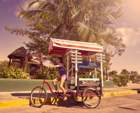 Young girl with caribbean bicycle shop on tricycle of Mexico