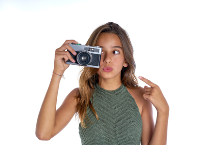 Brunette teen girl vintage photo camera portrait on white backgroundの写真素材