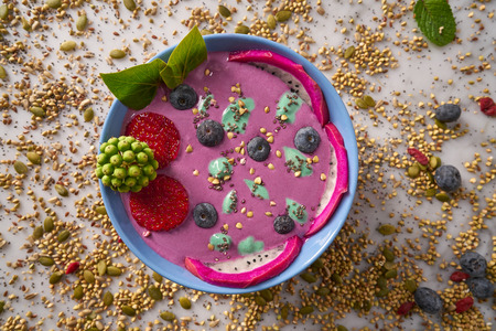 Acai bowl smoothie with chia strawberry blueberry seeds and pitaya dragon fruitの写真素材
