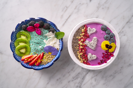 Acai bowl smoothie and Spirulina algae healthy breakfast with seeds and berriesの写真素材