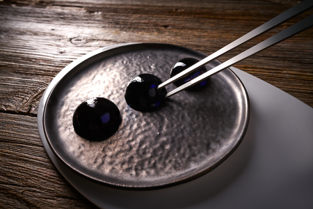 Molecular cuisine concept spheritions black jelly textureの写真素材