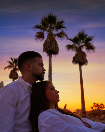 Couple young hug in beach vacation sunrise in Spainの写真素材