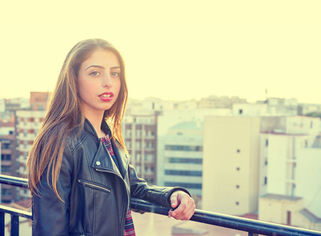Teenager rock girl standing outdoor at roof terrace in the cityの写真素材