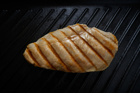 grilled chicken breast on grill pan backgroundの写真素材