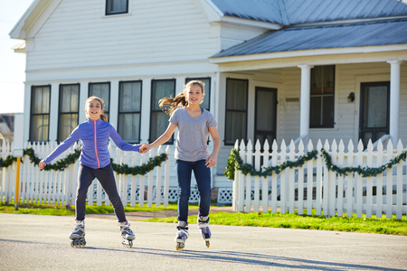 Teen girls group rolling skate in the street outdoorの写真素材