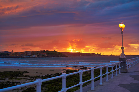 Gijon skyline sunset in San Lorenzo beach of Asturias in Spainの写真素材