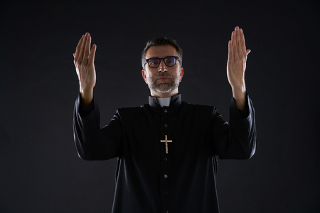 Priest open arms blessing praying God gesture isolatedの写真素材