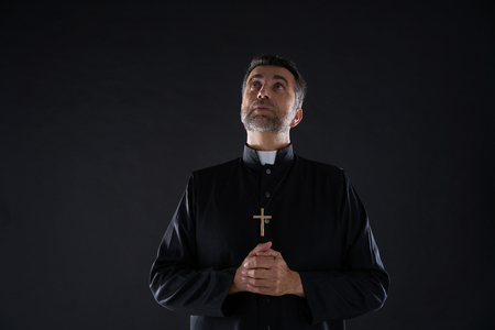 Priest looking up head eyes to heaven sky praying for Godの写真素材