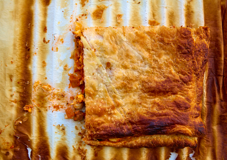 Tomato ratatouille pie with puff pastry on a oven paperの写真素材