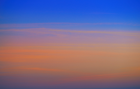 Sunset sky clouds orange and blue colorsの写真素材