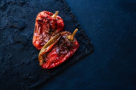 Roasted red peppers in black tray backgroundの写真素材
