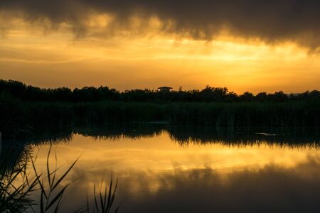 Orange sunset in one of the lagoons of the natural park of the tablesの写真素材