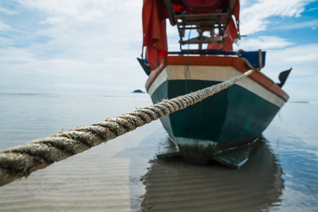 Boat rope to anchor on the beachの写真素材