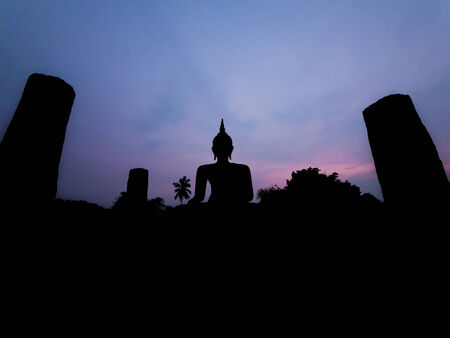 Silhouette buddha image at twilight at Wat Mahathat Sukhothai Thailandの写真素材