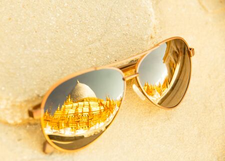 Surface blurry Sunglasses put on the floor reflect  old pagoda Bagan, Myanmar.の写真素材