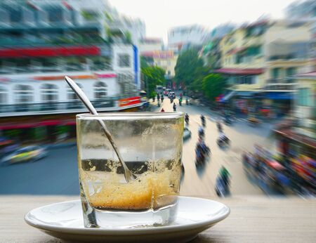 Coffee mugs on the table in front of window with Colorful zoom with street,traffic lighting in the...