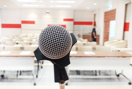 Close up of microphone in concert hall or medical conference room and blurry emergency medical student blcak viesw.の写真素材