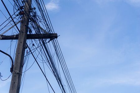 Close up Old Electricity poles with telephone lines Many. under sky background.Electric and...