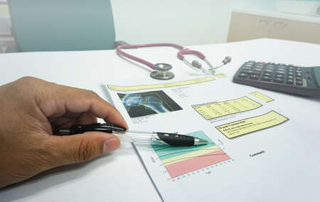 Soft and blurry image:Bone Densitometer hip  report paper  .on the teble doctor room white...