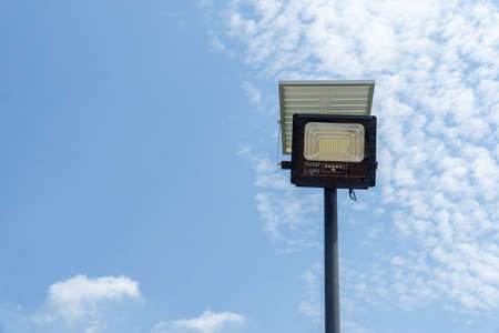 Close up street or garden lamp post with solar cell panel energy (against blue sky...