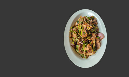 Thai street food dish with taste hot and spicy. Northeastern Thai cuisine food, they are the most popular food in Thailand, The famous local, with spicy minced pork meat salad isolated on black background.の写真素材