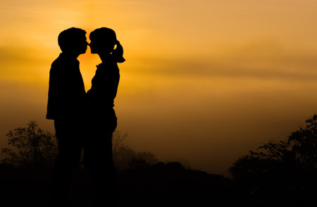 Close-up silhouette of a happy Couple on the mountain views and Sunrise background.の写真素材