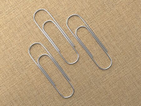 Paperclips laying on canvasの写真素材
