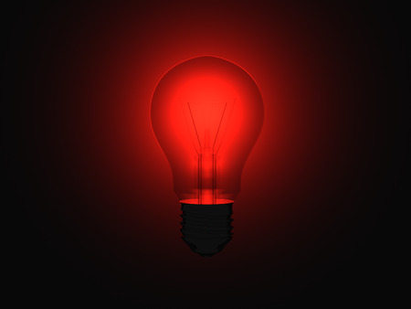 Illuminating red light bulb within a full dark room.の写真素材