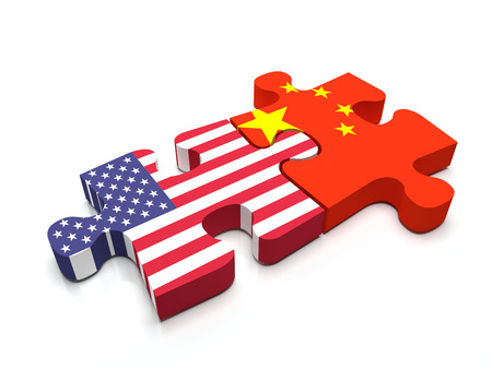 Puzzle pieces connect a piece containing the chinese flag and the US flag.の写真素材