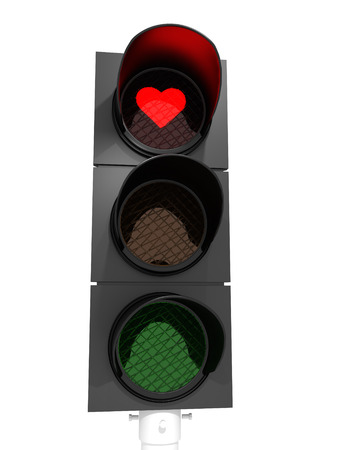 A traffic light showing a red heart in the red light.の写真素材