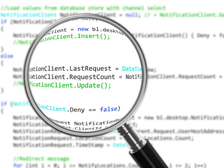 Magnifying Glass focussed on source codeの写真素材