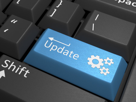 Software Update - A blue key on a black keyboard containing the text update.の写真素材
